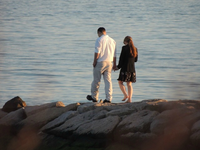 asian couple walking on pier together,love display