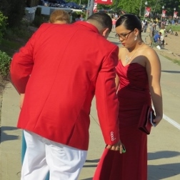 couple dressed in red prom outfit, love display