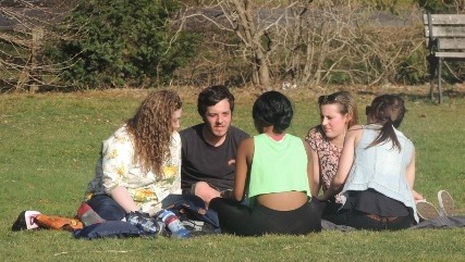 friends sitting on grass together,display of love pic