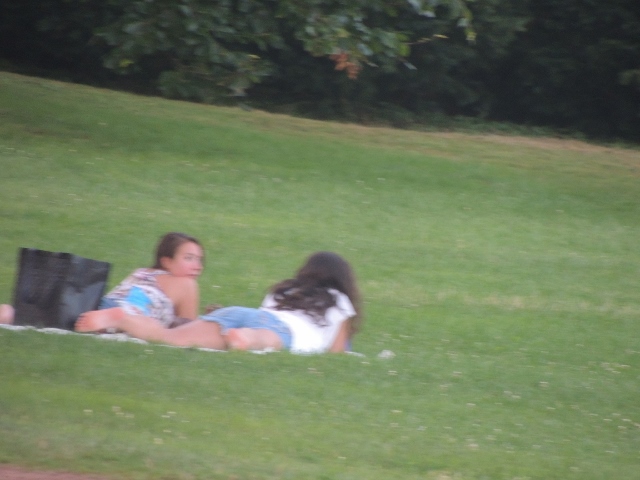 girls lying on grass together,photo images