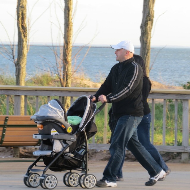man pushing stroller on boardwalk,love display pic