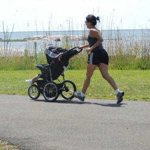 woman jogging with baby in stroller,love display