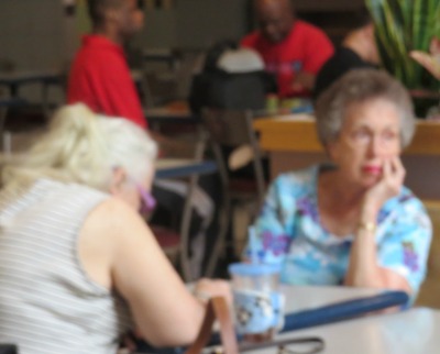 woman sitting in mall hand under chin woman sitting in mall under chin,pictures