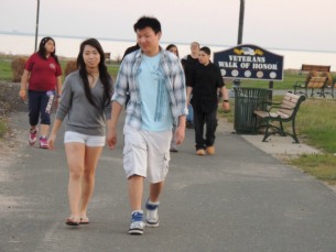 young asian couple walking on beach,pictures